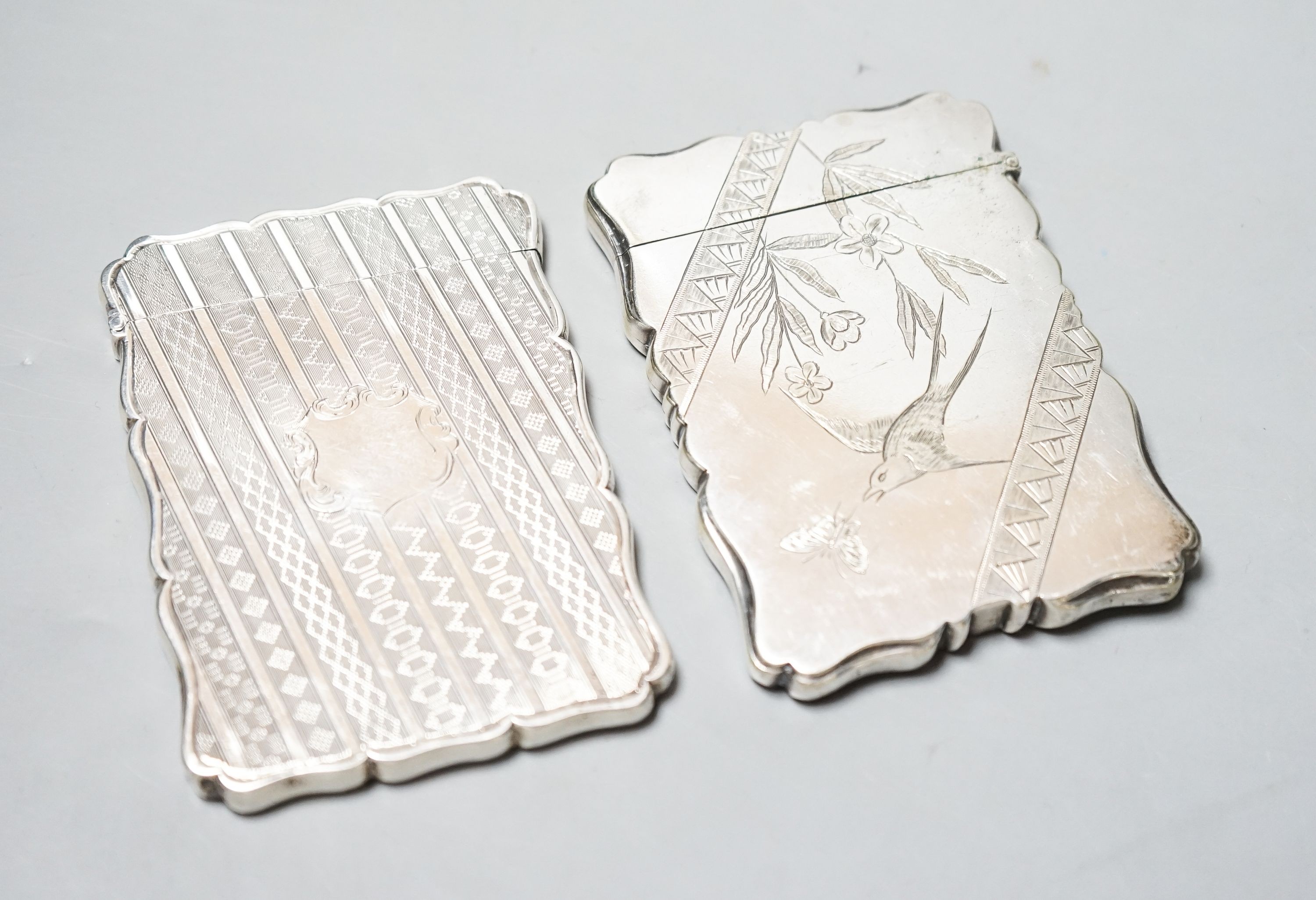 A Victorian engraved silver card case, Edward Smith, Birmingham, 1865, 9.8cm and a silver plated card case with engraved aesthetic decoration.